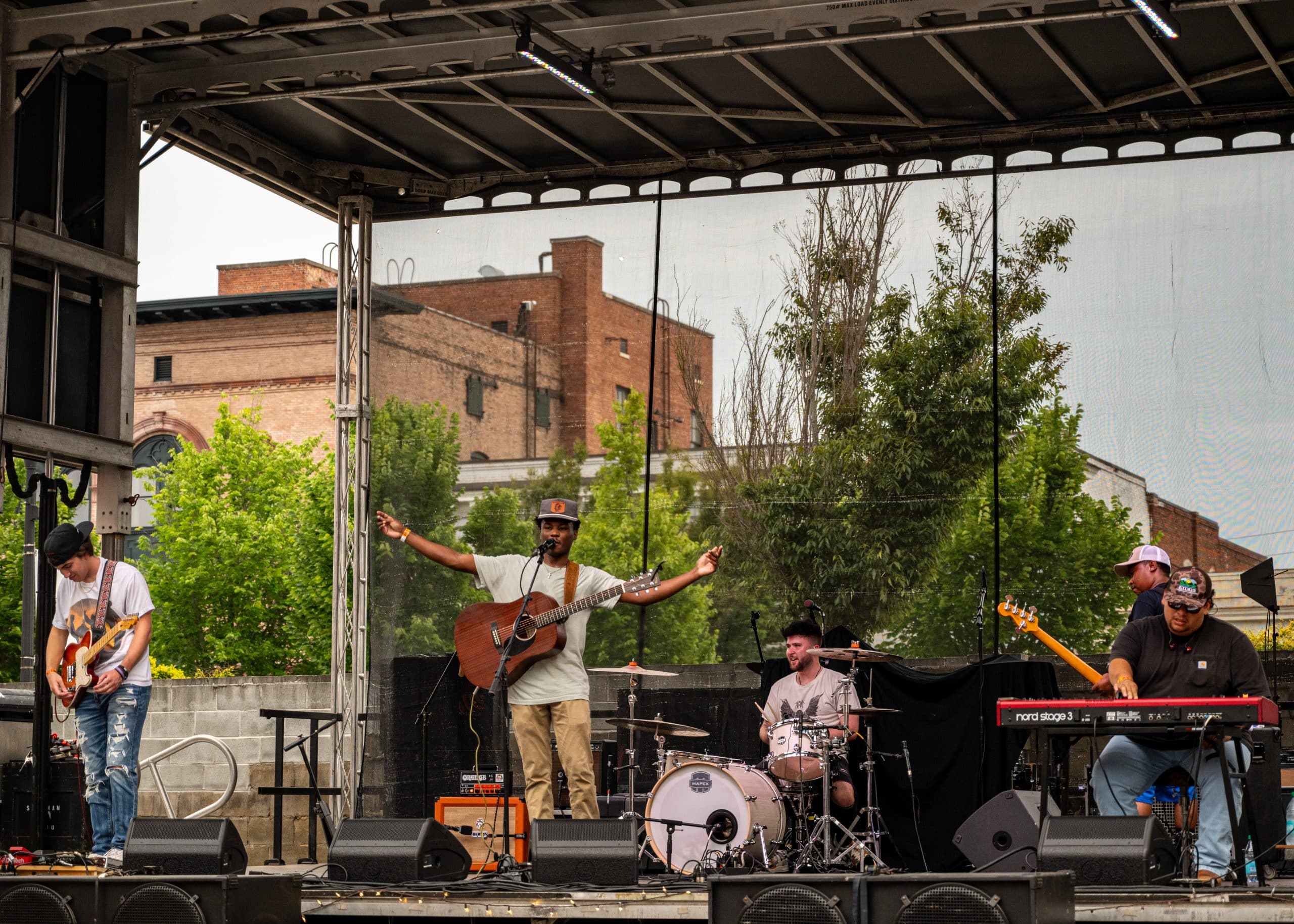 A band performs a concert on stage in front of fans