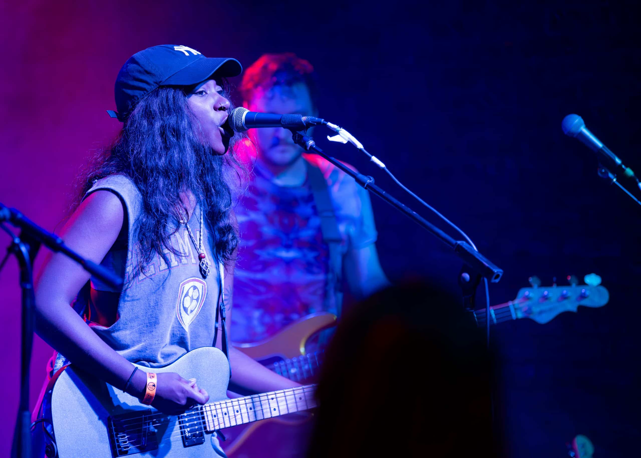 A band performs a concert on stage in front of fans