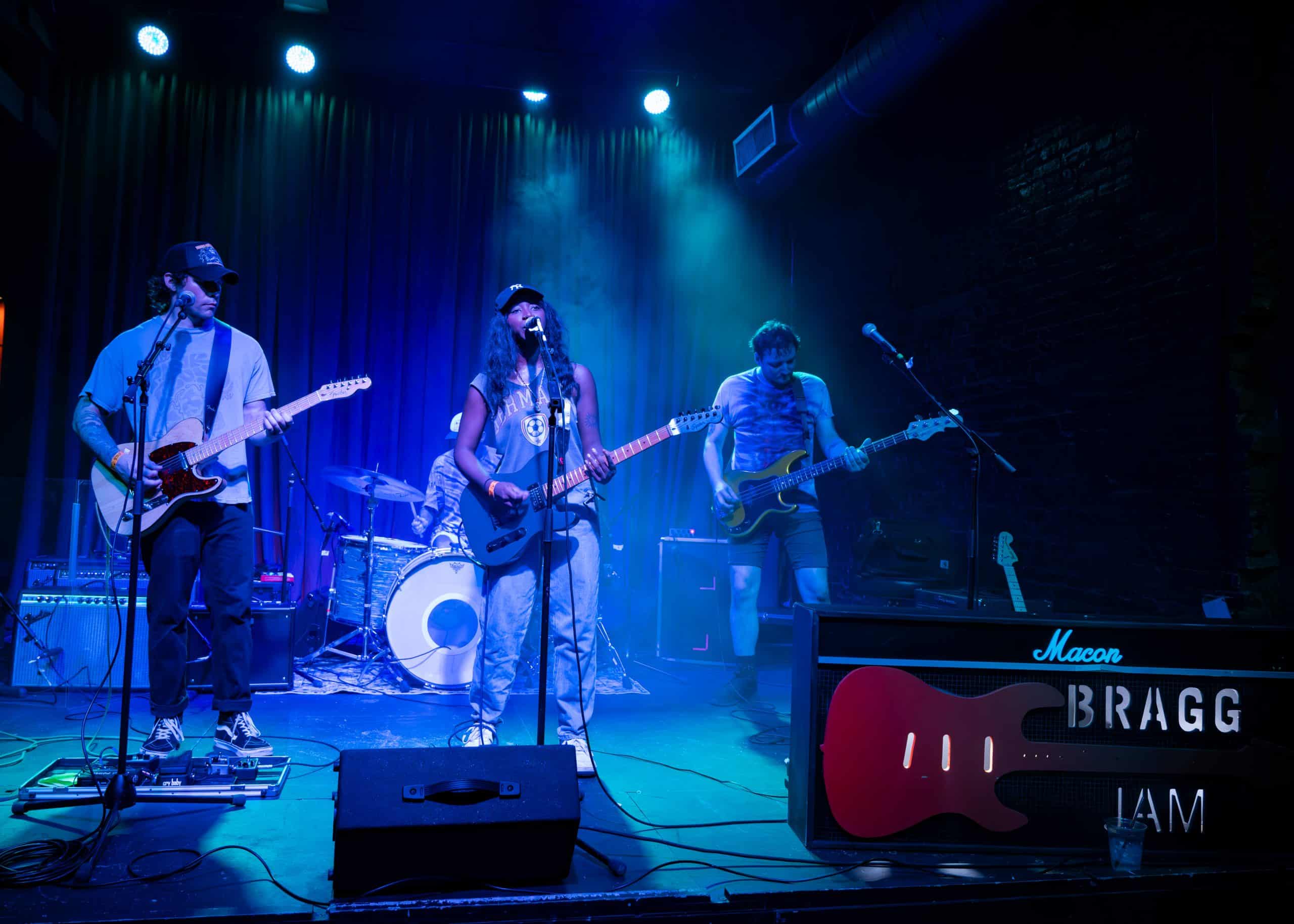 A band performs a concert on stage in front of fans