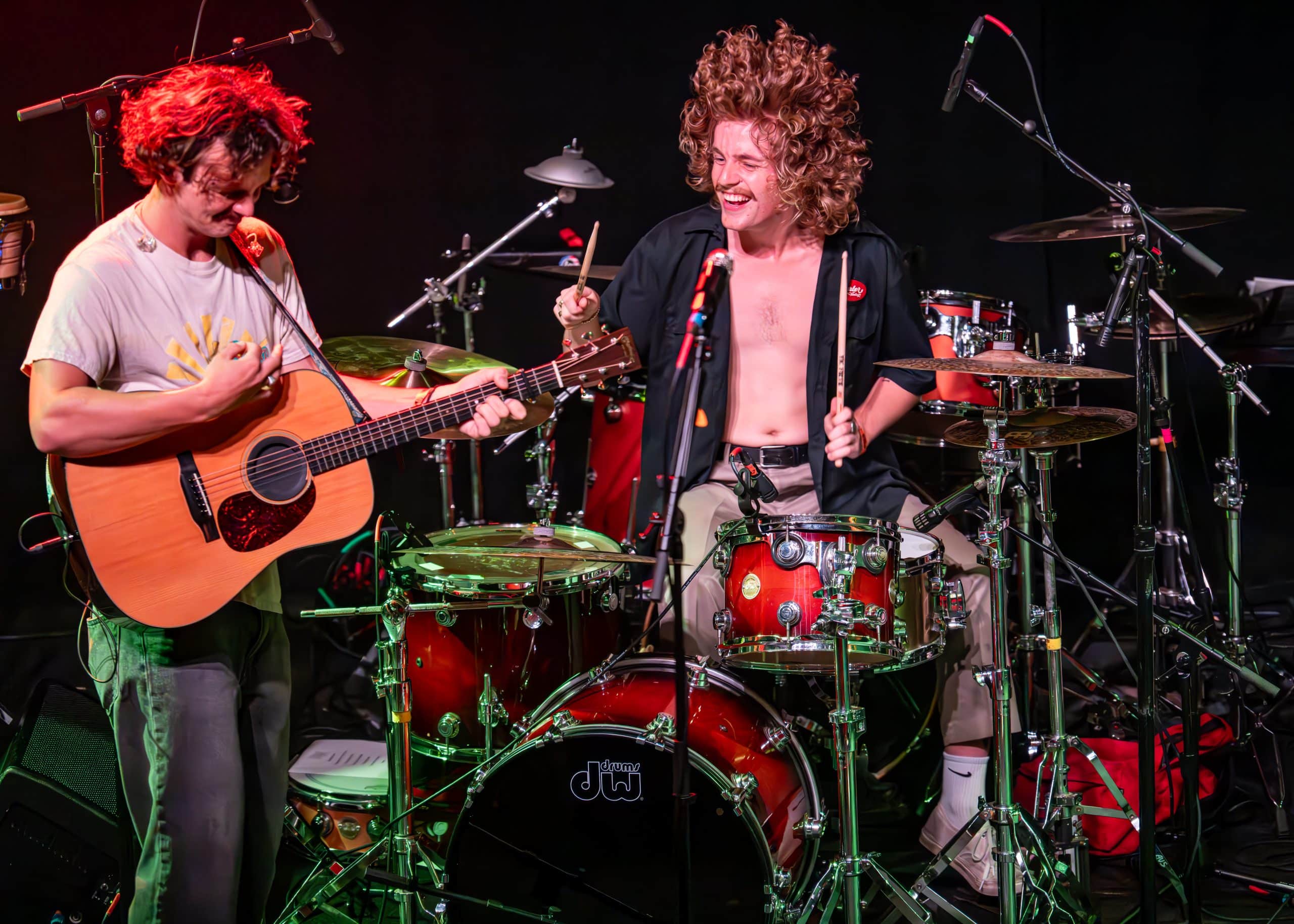 A band performs a concert on stage in front of fans