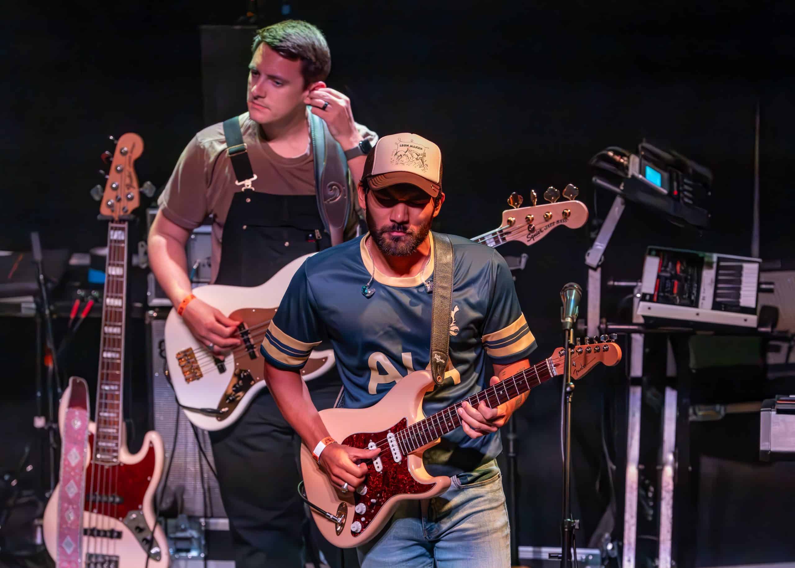 A band performs a concert on stage in front of fans