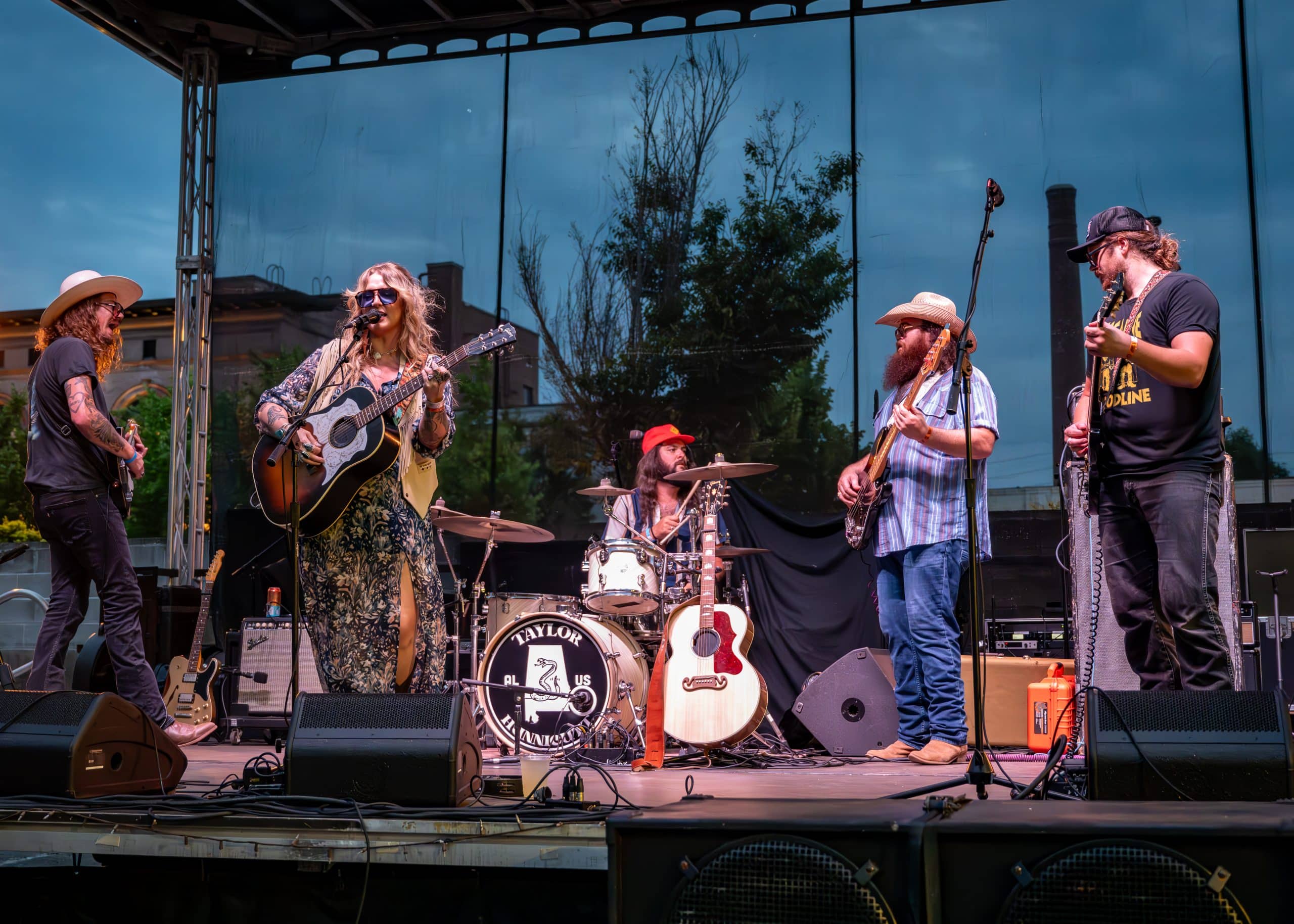 A band performs a concert on stage in front of fans