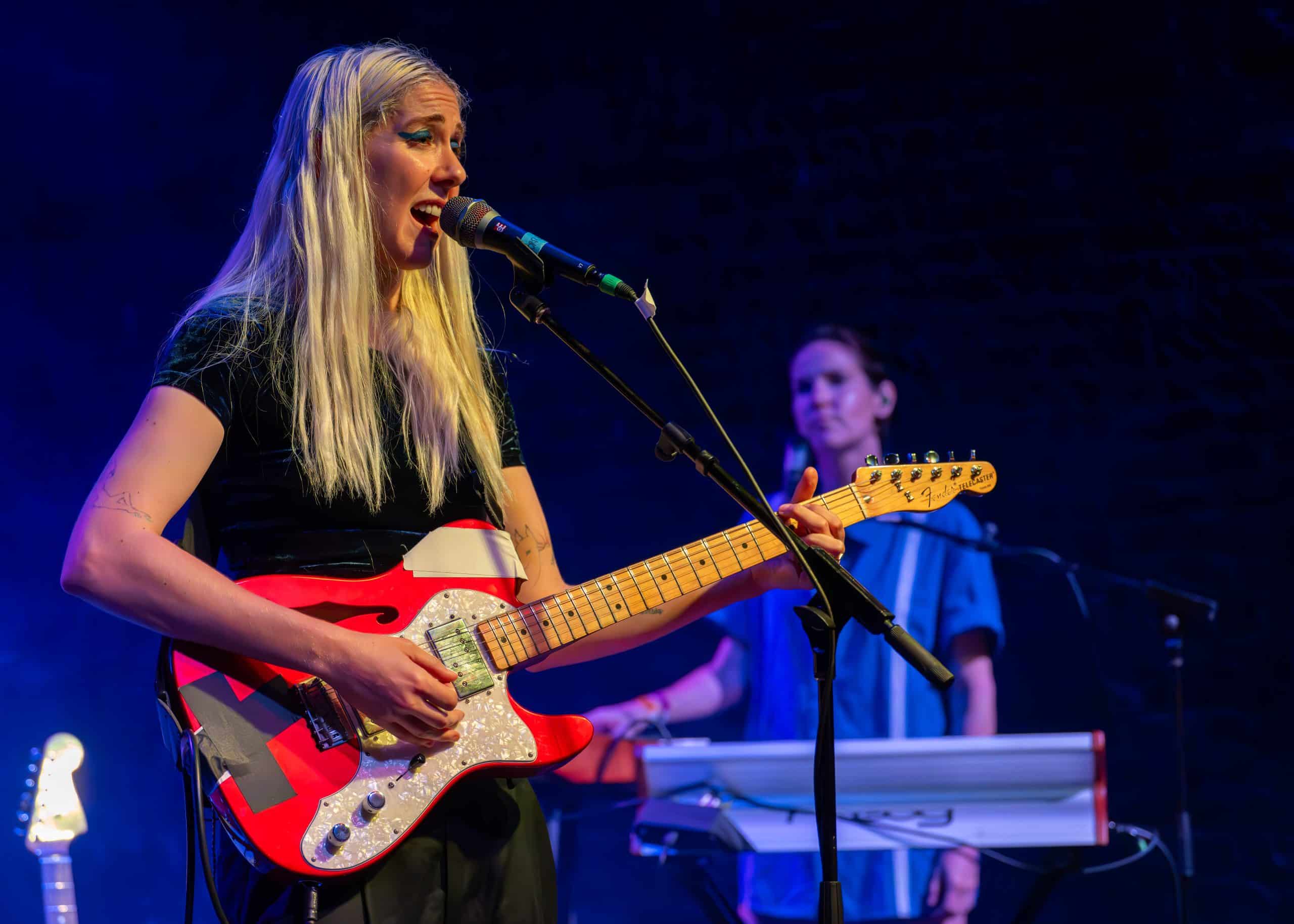 A band performs a concert on stage in front of fans