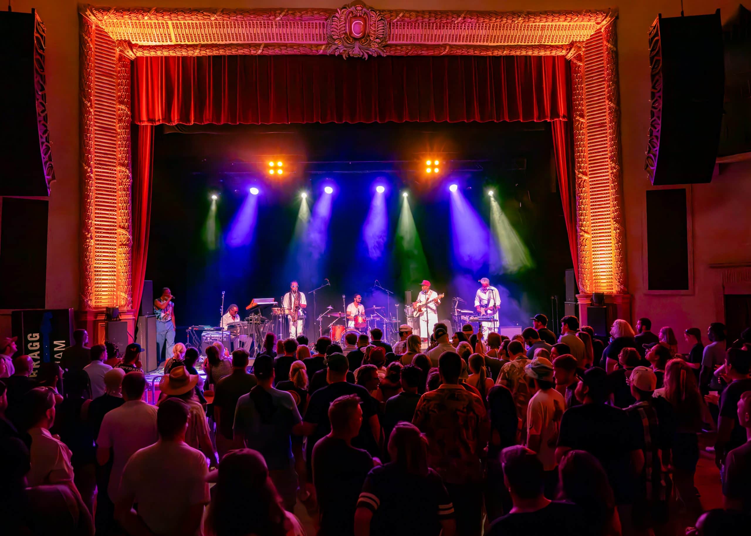 A band performs a concert on stage in front of fans