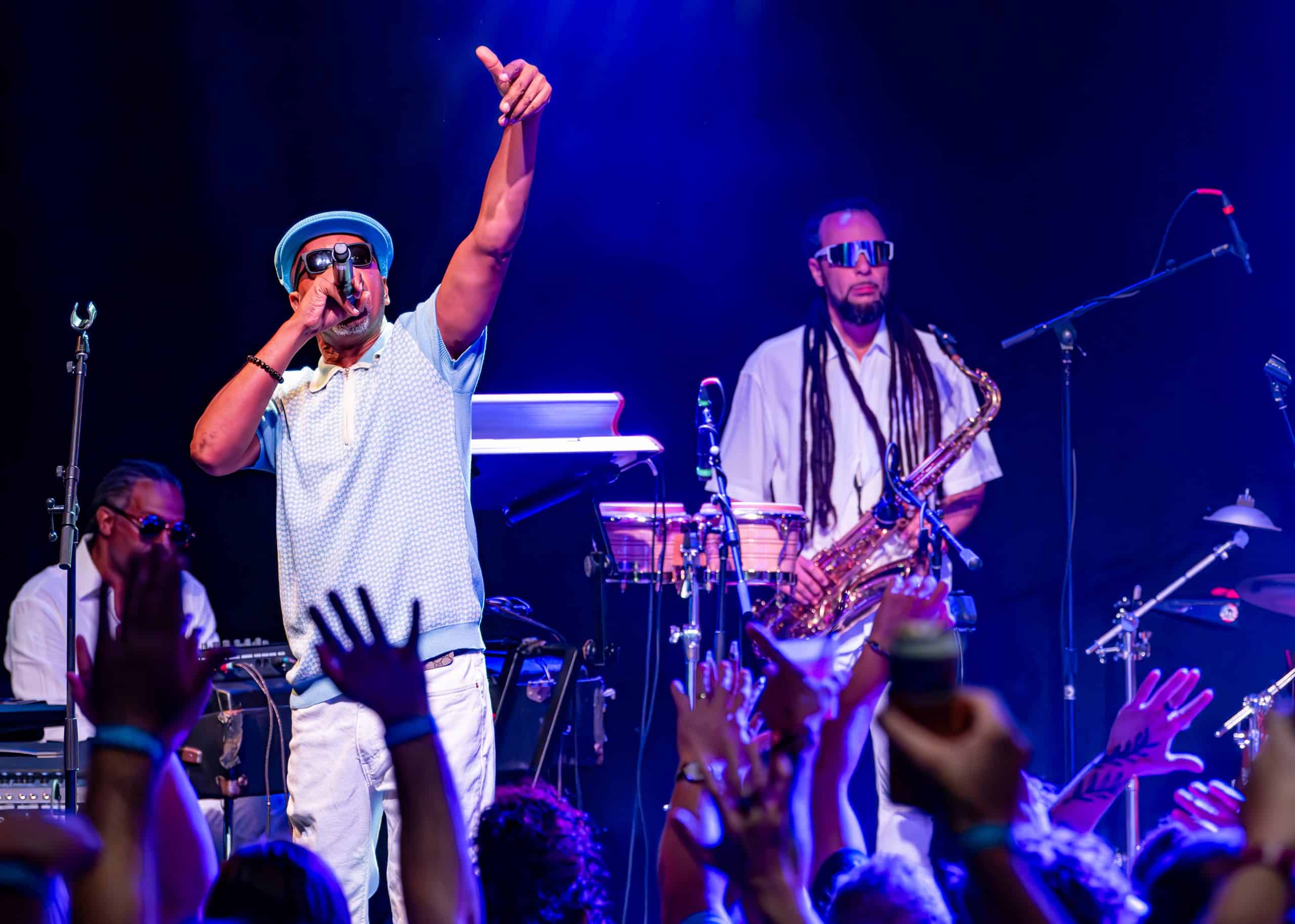 A band performs a concert on stage in front of fans