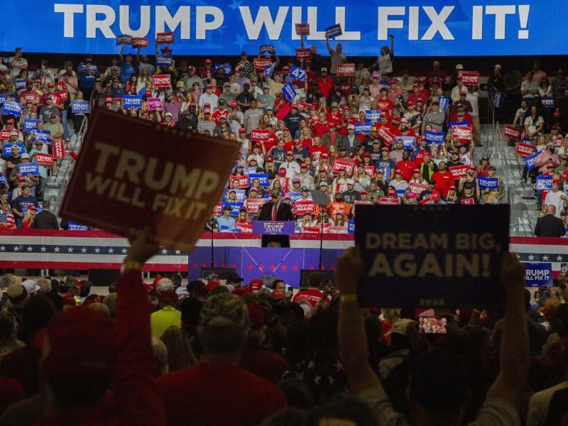 A wall of people in the background behind Donald Trump