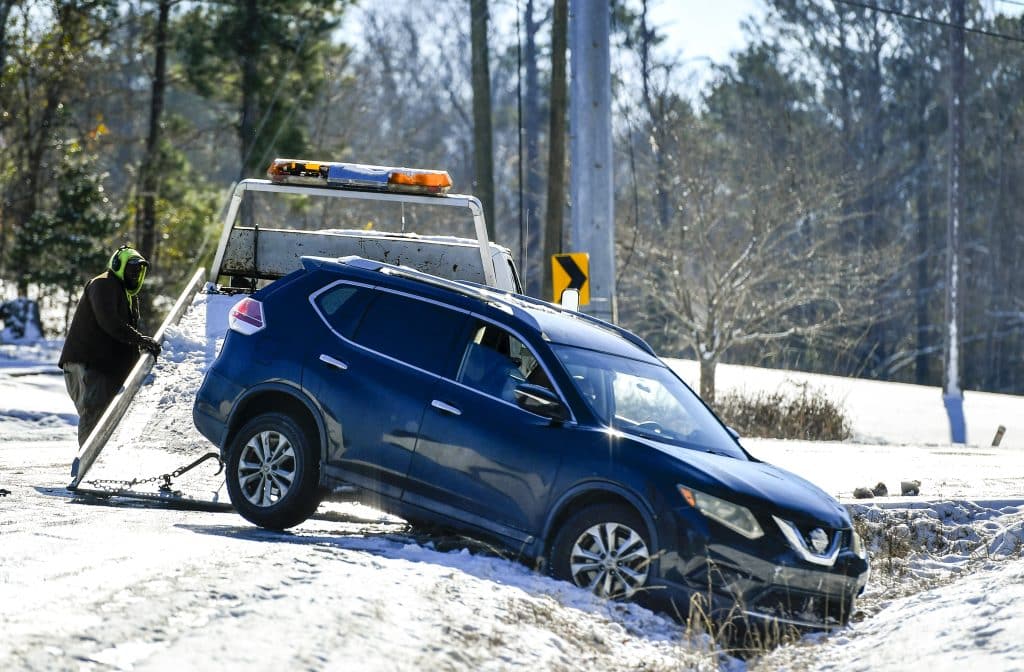 A car in a snowy ditch.